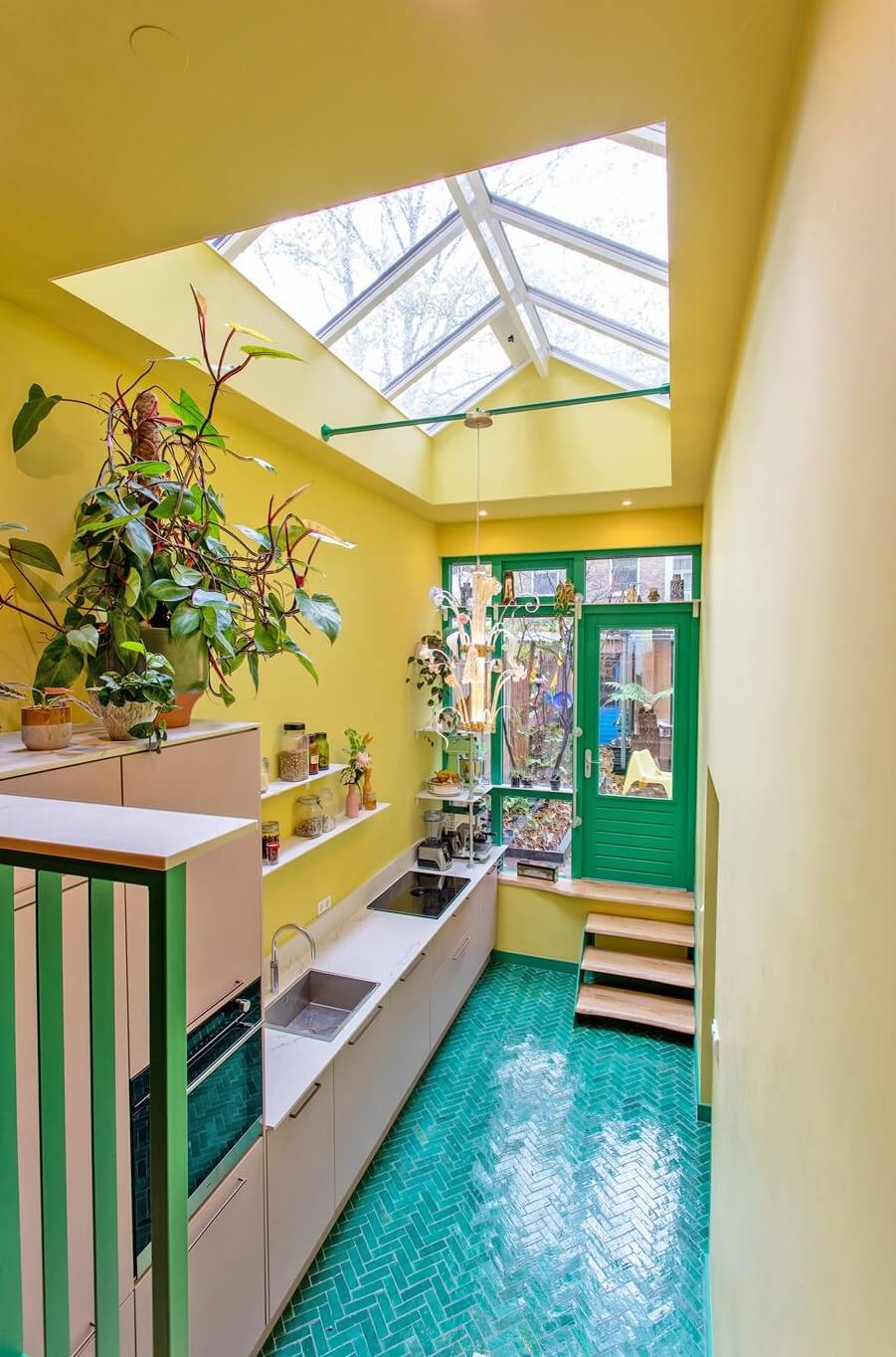 Trend Alert: 36x Color-Drenched Rooms 7 kitchen with yellow walls blue floor tiles and light pink cabinets nordroom
