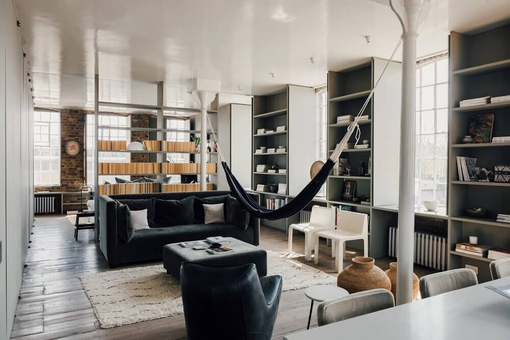 A London Loft Designed By Ilse Crawford And Vincent van Duysen 1 london-loft-ilse-crawford-vincent-van-duysen-grey-bookshelves-hammock-nordroom