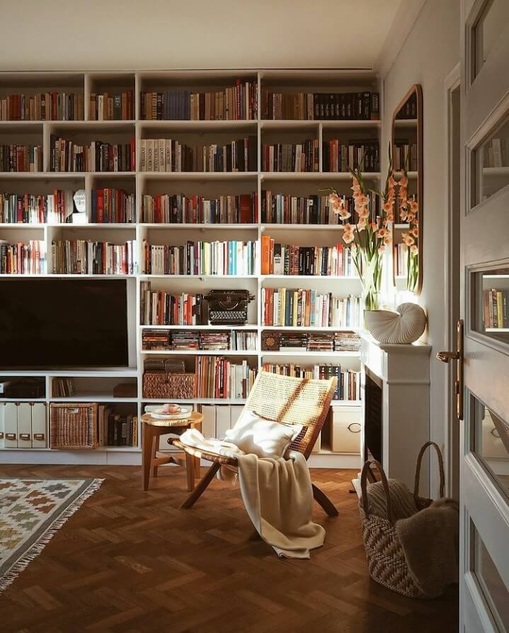 36 Home Library Ideas That Are A Book-Lover's Dream 11 reading-nook-fireplace-natural-light-warm-apartment-nordroom