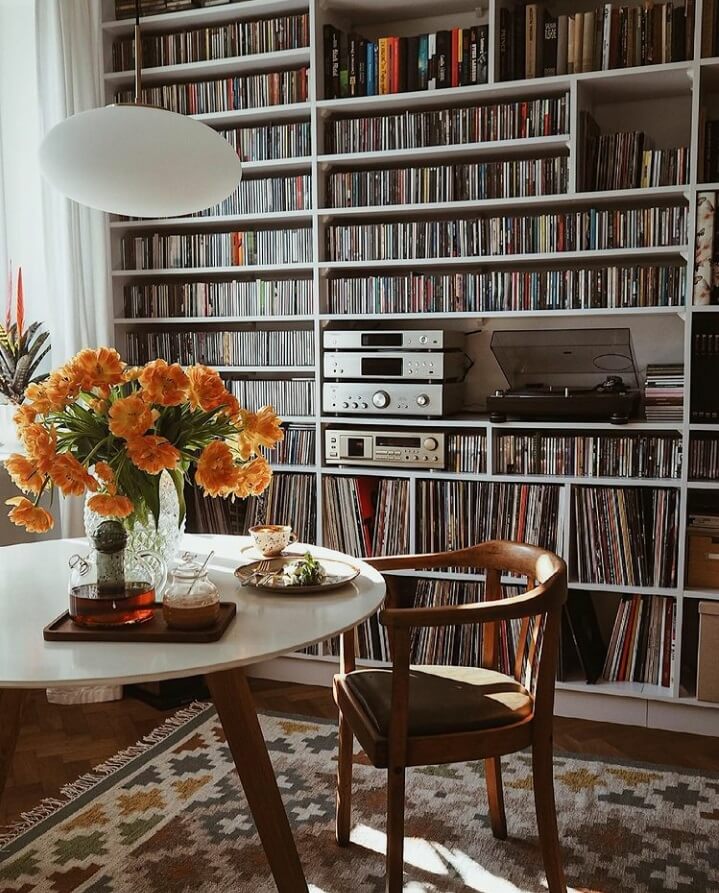 36 Home Library Ideas That Are A Book-Lover's Dream 12 round-table-music-corner-warm-apartment-poland-nordroom