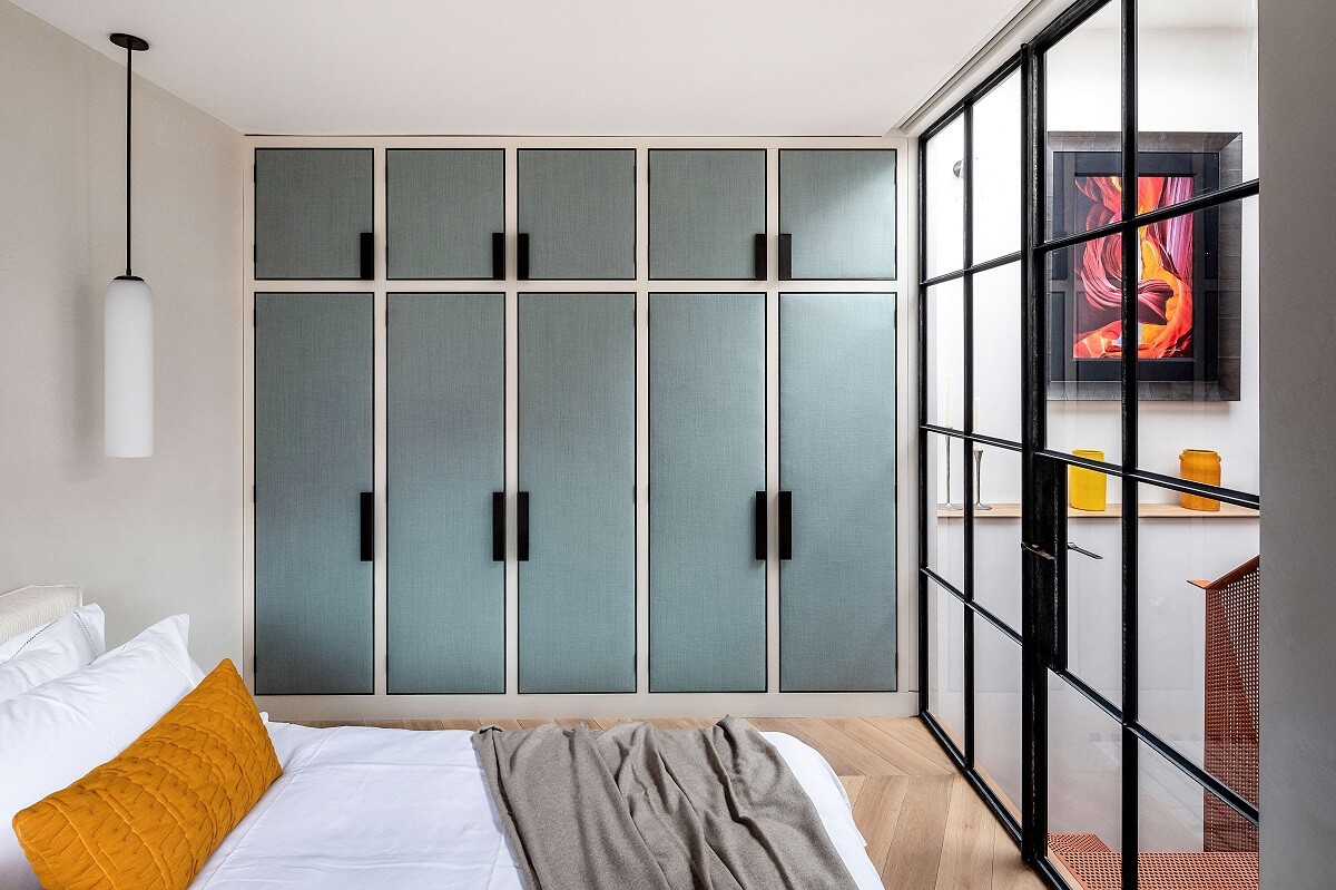 A Modern Playful Mews House in London 10 bedroom-blue-closets-steel-glass-wall-nordroom