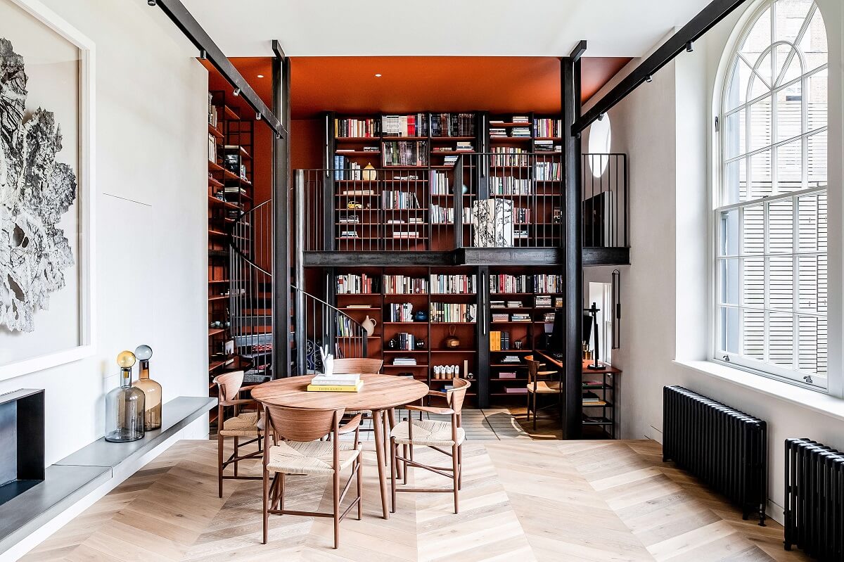 A Modern Playful Mews House in London 1 double-height-living-bookshelves-red-wall-arched-windows-mews-house-nordroom