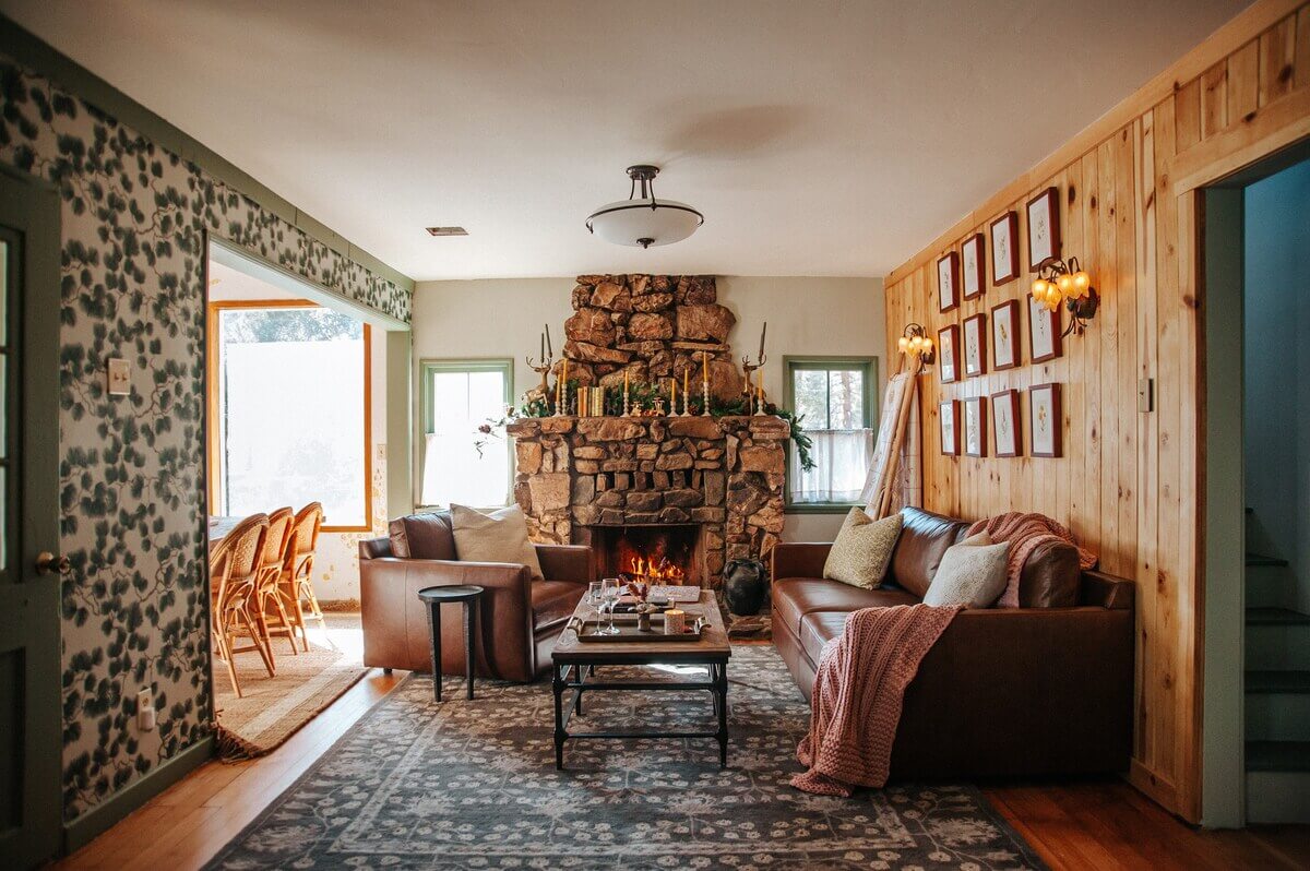 An Interior Designer's Colorful Airbnb Cabin 1 rustic-living-room-fireplace-wooden-walls-airbnb-cabin-nordroom