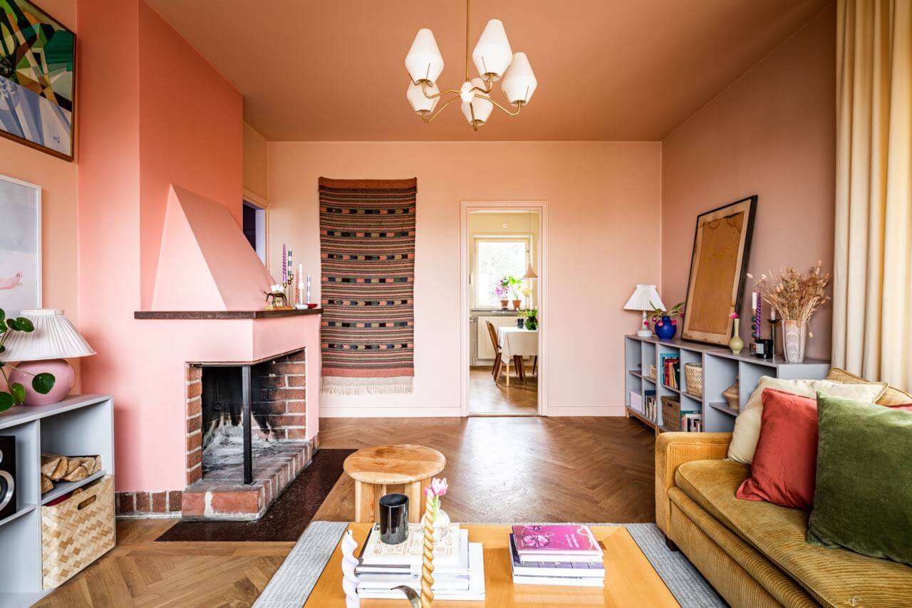 A Pink and Yellow Scandinavian Apartment 4 pink-living-room-ochre-sofa-fireplace-nordroom