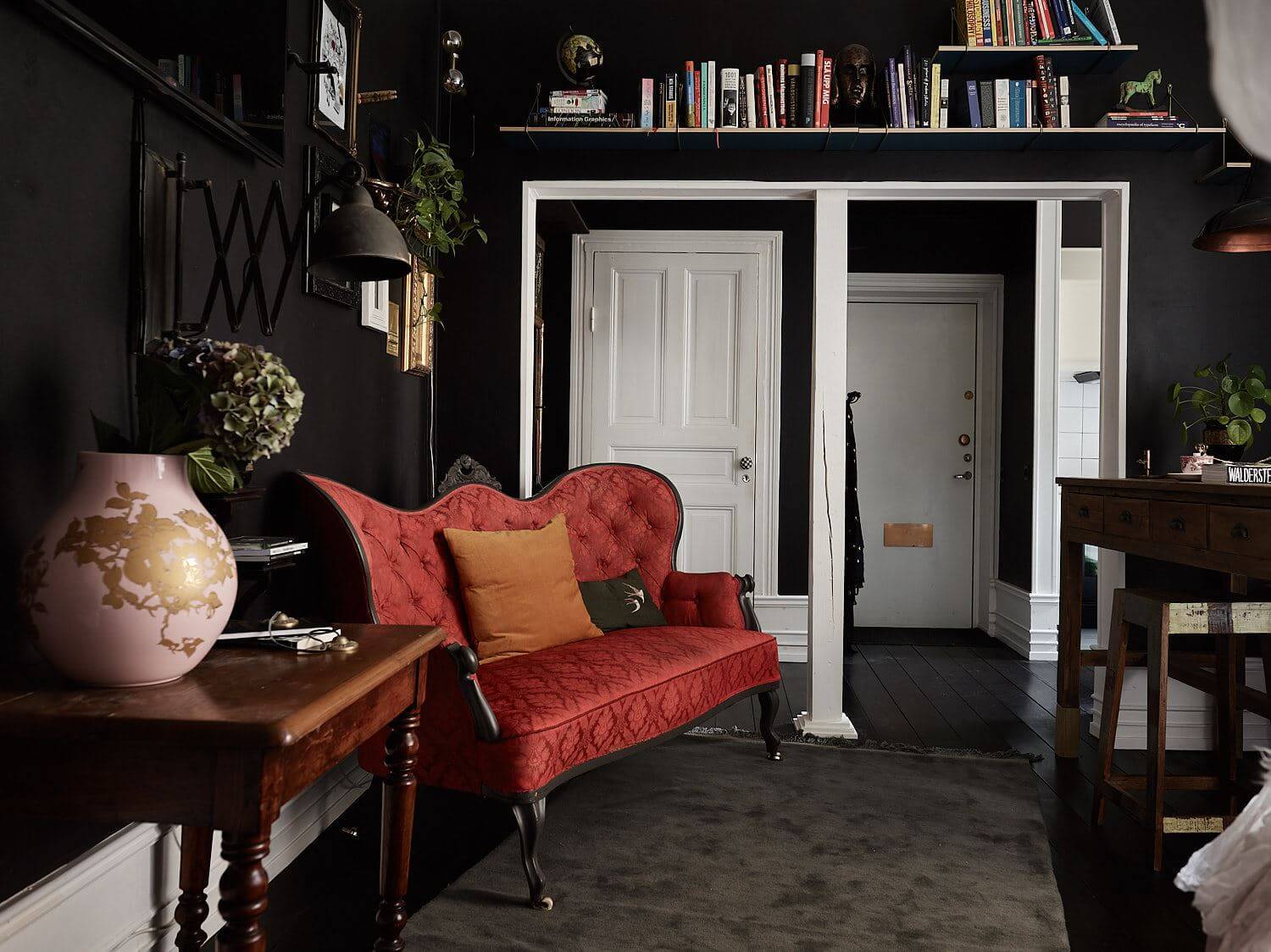 Best of 2022: Studio Apartments 9 black-studio-apartment-red-vintage-sofa-bookshelves-nordroom