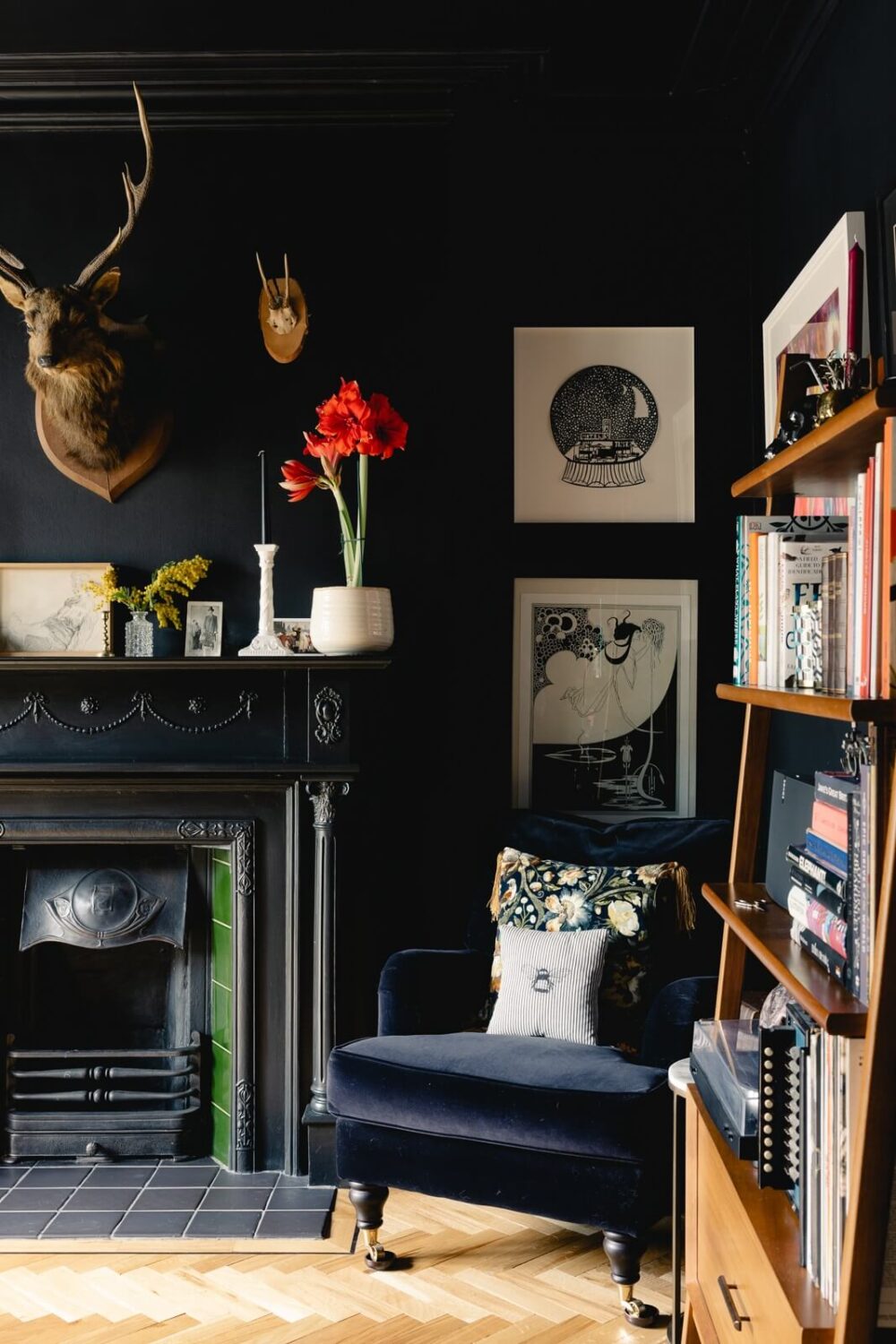 A Green Kitchen with Pink Ceiling in a Colorful London Home 8 moody-blue-dining-room-velvet-blue-chair-black-fireplace-nordroom