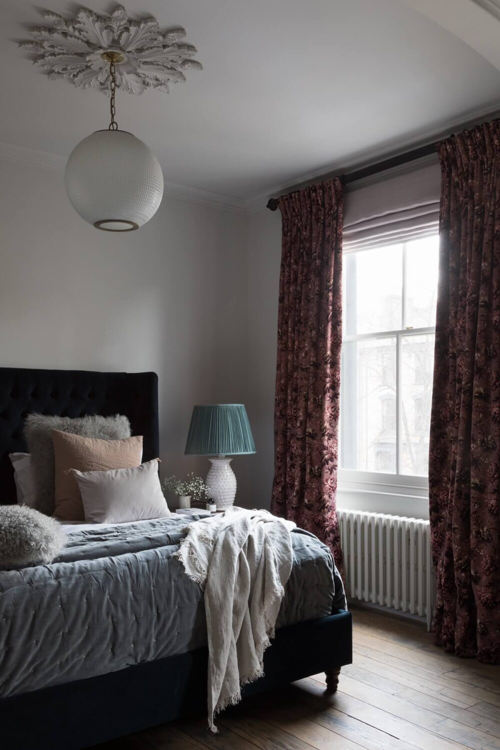 Contrasting Styles in a Victorian Home in London 21 bedroom-dark-blue-velvet-bedframe-ceiling-rosette-victorian-home-london-nordroom