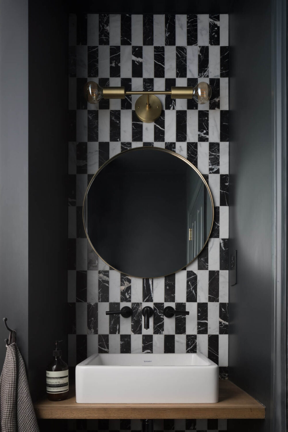 Contrasting Styles in a Victorian Home in London 27 powder-room-round-mirror-black-white-tiles-nordroom