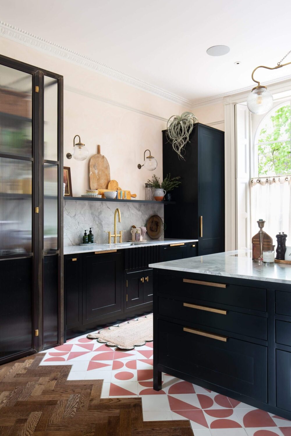 A Colorful Georgian Home in London 1 kitchen-dark-blue-cabinets-open-shelf-glass-cabinets-pink-white-floor-tiles-nordroom