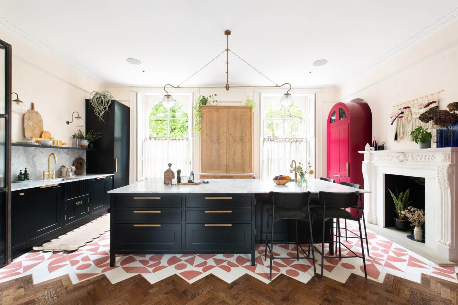 A Colorful Georgian Home in London 2 kitchen-island-dark-blue-cabinets-pink-white-floor-tiles-pink-cabinets-fireplace-nordroom