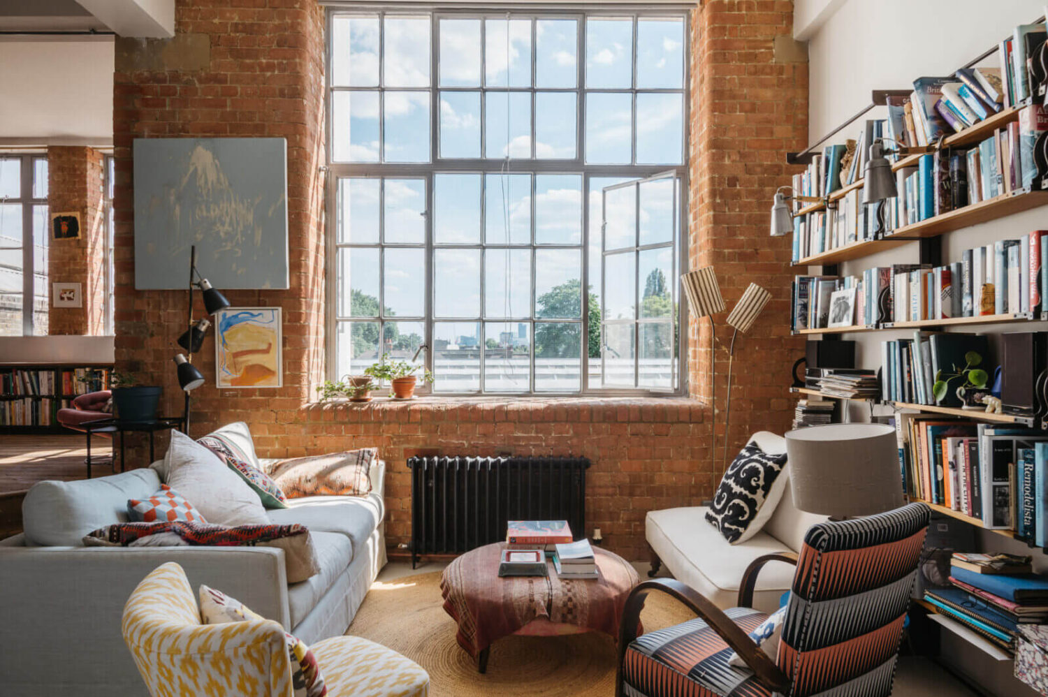 A Loft-Style Apartment with Brick Walls in London 2 loft-style-sitting-room-brick-walls-bookshelves-nordroom