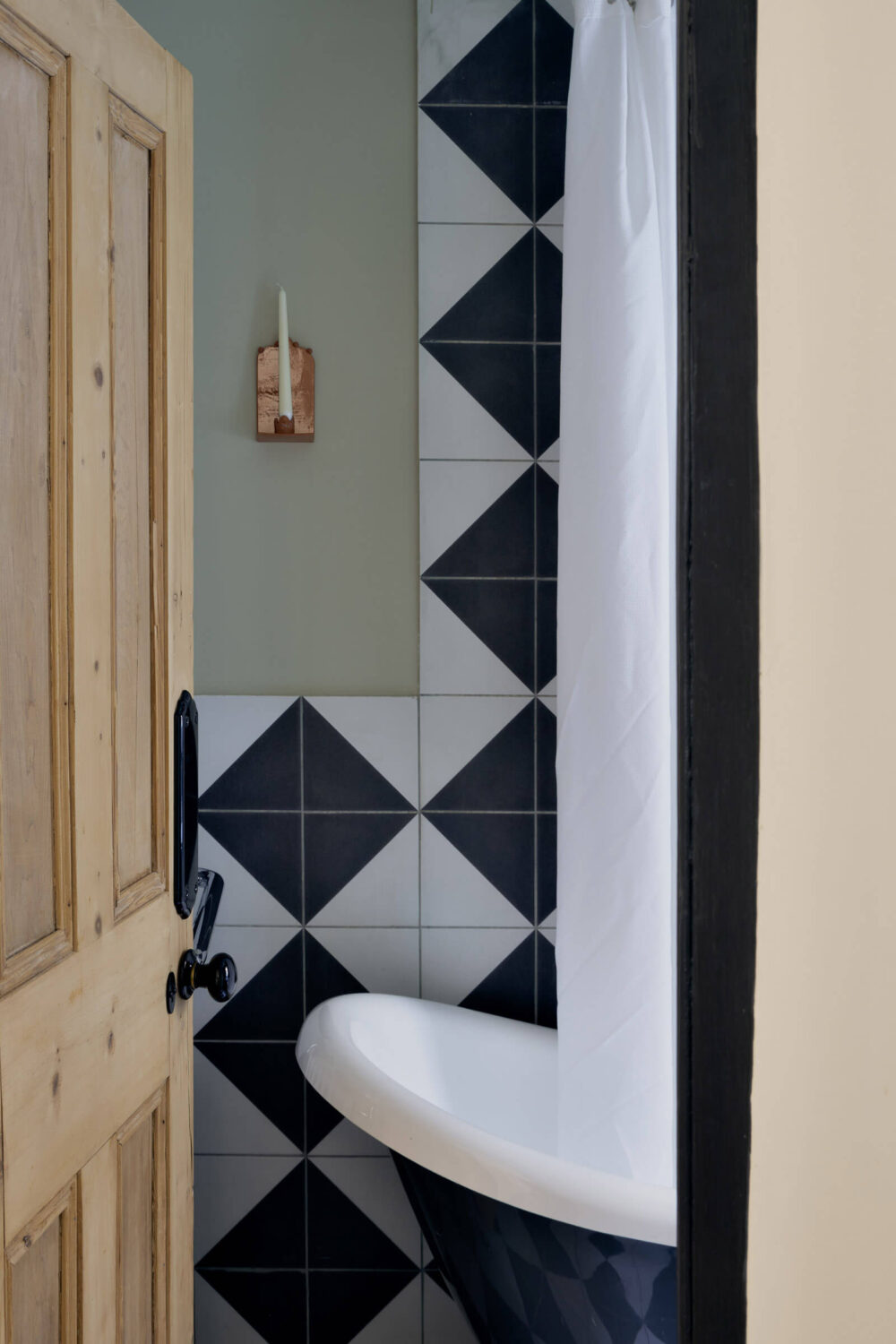 A One-Bedroom Apartment with Colorful Rooms 12 bathroom-gray-walls-black-white-tiles-freestanding-bath-nordroom