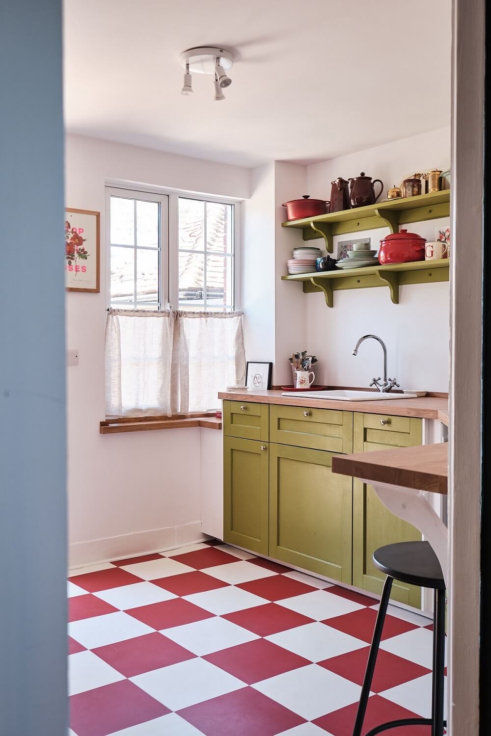 Bold Colors in a Charming English Cottage 6 colorful-english-cottage-kitchen-green-cabinets-red-floor-nordroom