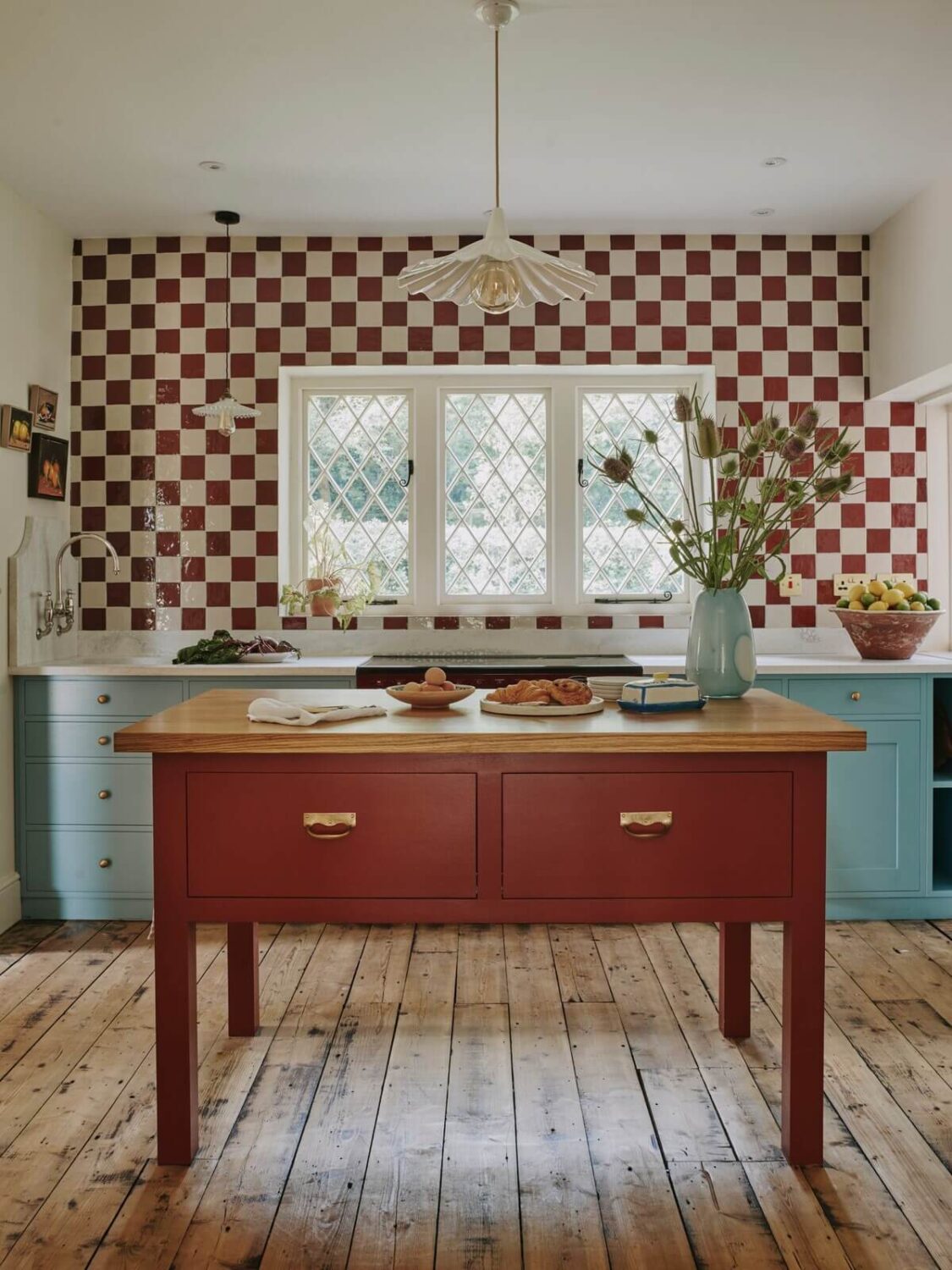A Magical Pink Cottage in the English Countryside 4 kitchen-wooden-floor-blue-cabinets-red-island-checkerboard-tiles-nordroom