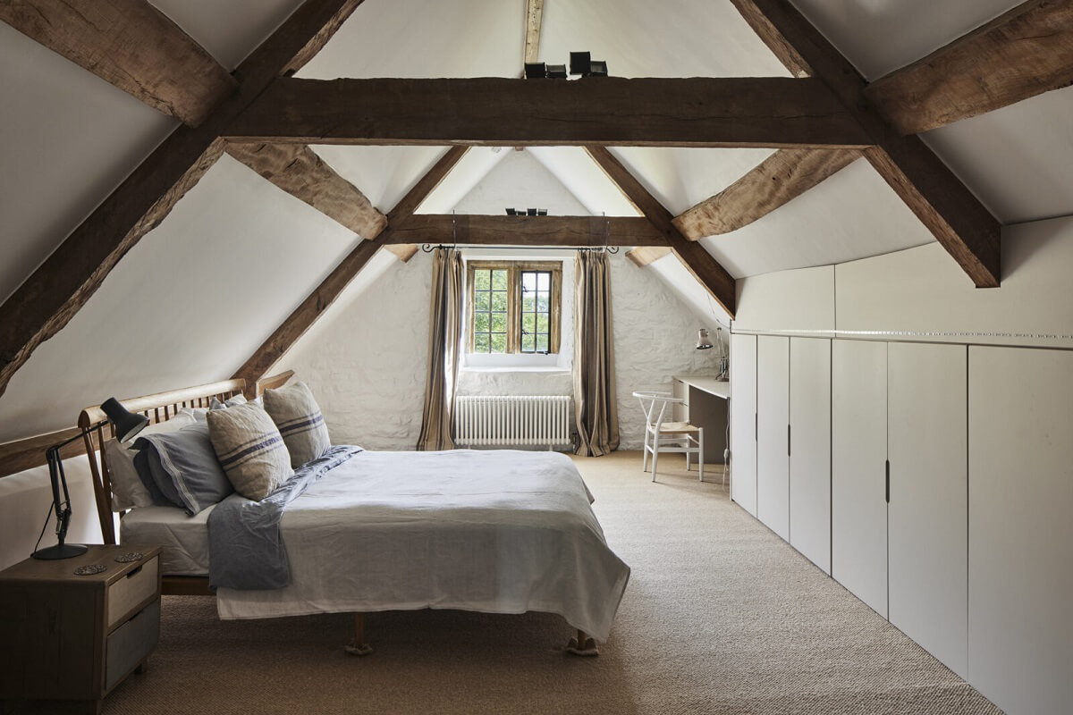 A Restored Elizabethan Manor House in England 18 attic-bedroom-exposed-wooden-beams-nordroom