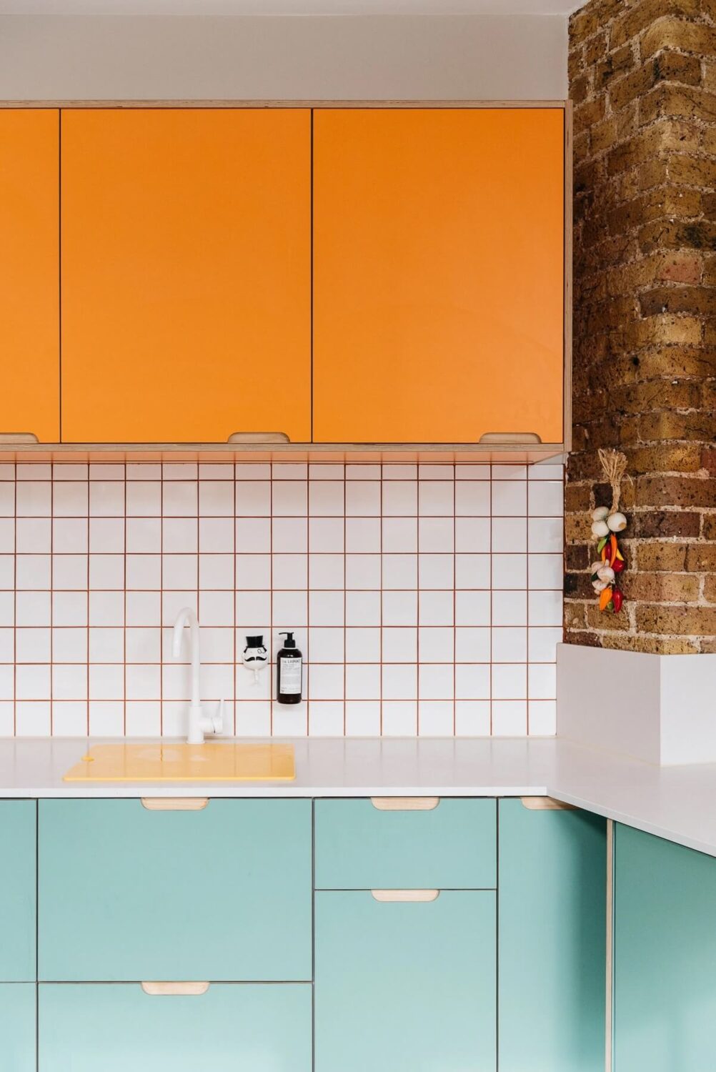 Colorful Kitchen Designs That Brighten Up Your Home 34 kitchen-blue-orange-cabinets-brick-wall-warehouse-apartment-london-nordroom