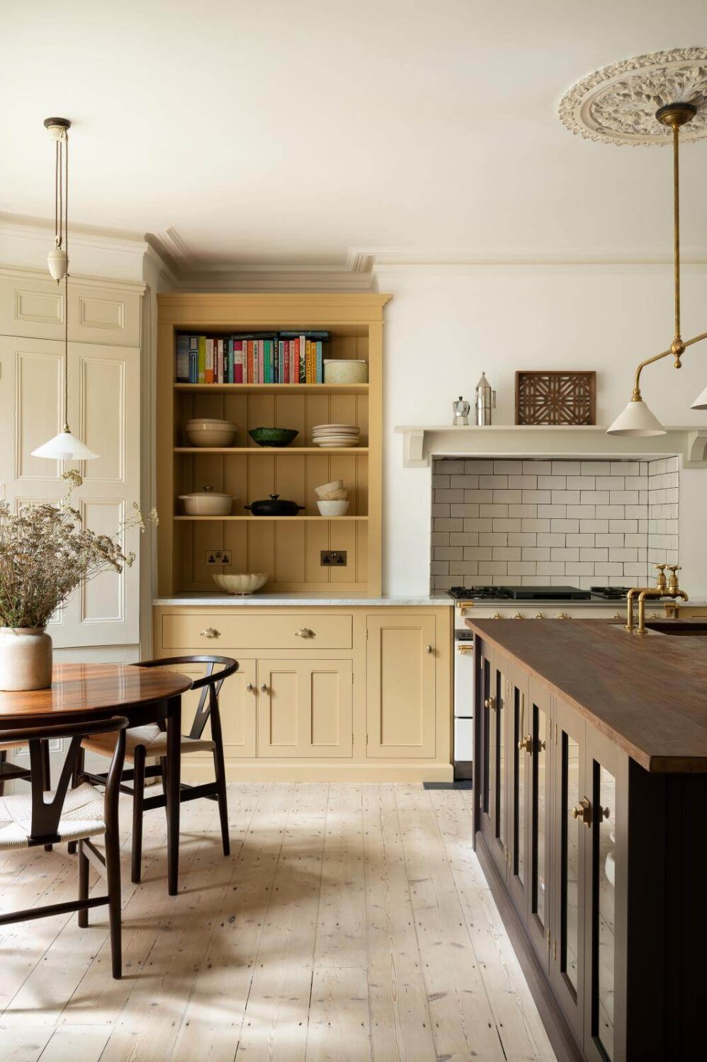 Best of 2022: Kitchens 8 kitchen-round-dining-table-island-yellow-cabinets-open-shelves-nordroom