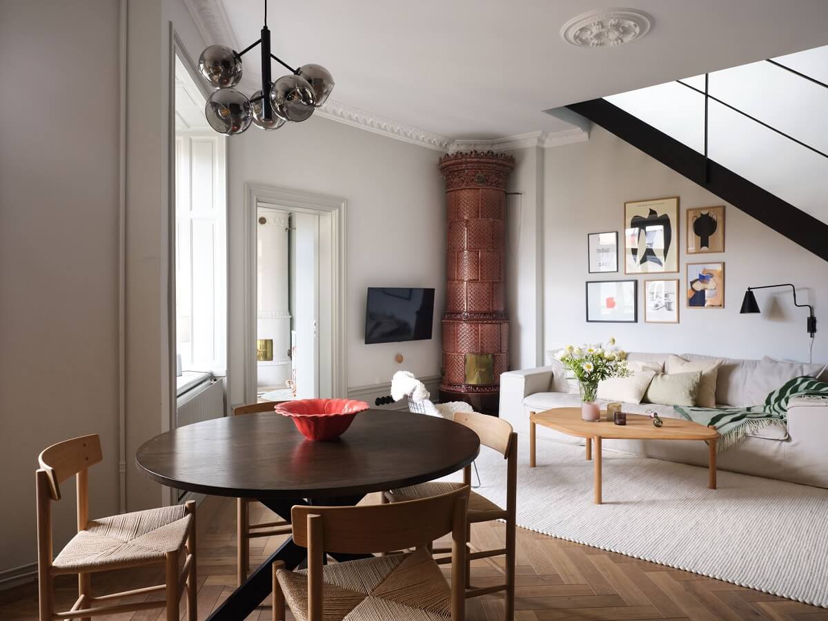 A Stylish Nordic Apartment with Attic Bedroom 1 open-plan-living-room-kitchen-round-dining-table-brown-fireplace-nordroom