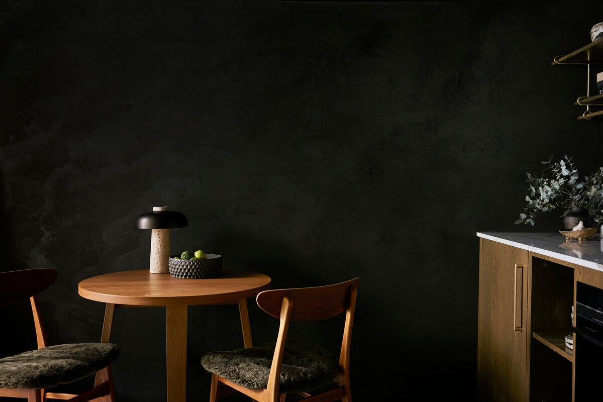 The River Studio: Moody Tones and Luxury in an Australian Airbnb 5 small-round-kitchen-table-black-walls-studio-apartment-nordroom