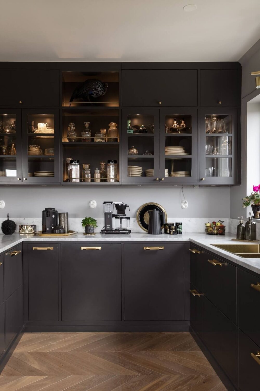 A Scandinavian Home with Purple Color Accents 15 gray-kitchen-brass-fixtures-nordroom