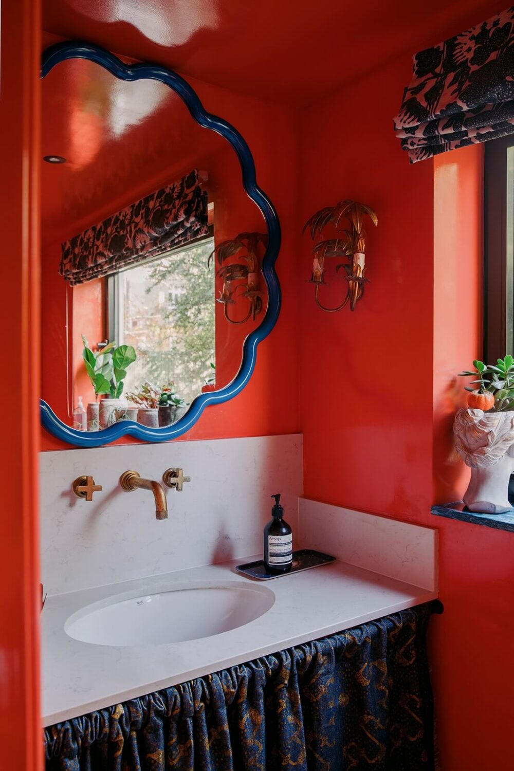 A Unique Colorful Family Home in London 9 powder-room-red-walls-sink-skirt-nordroom
