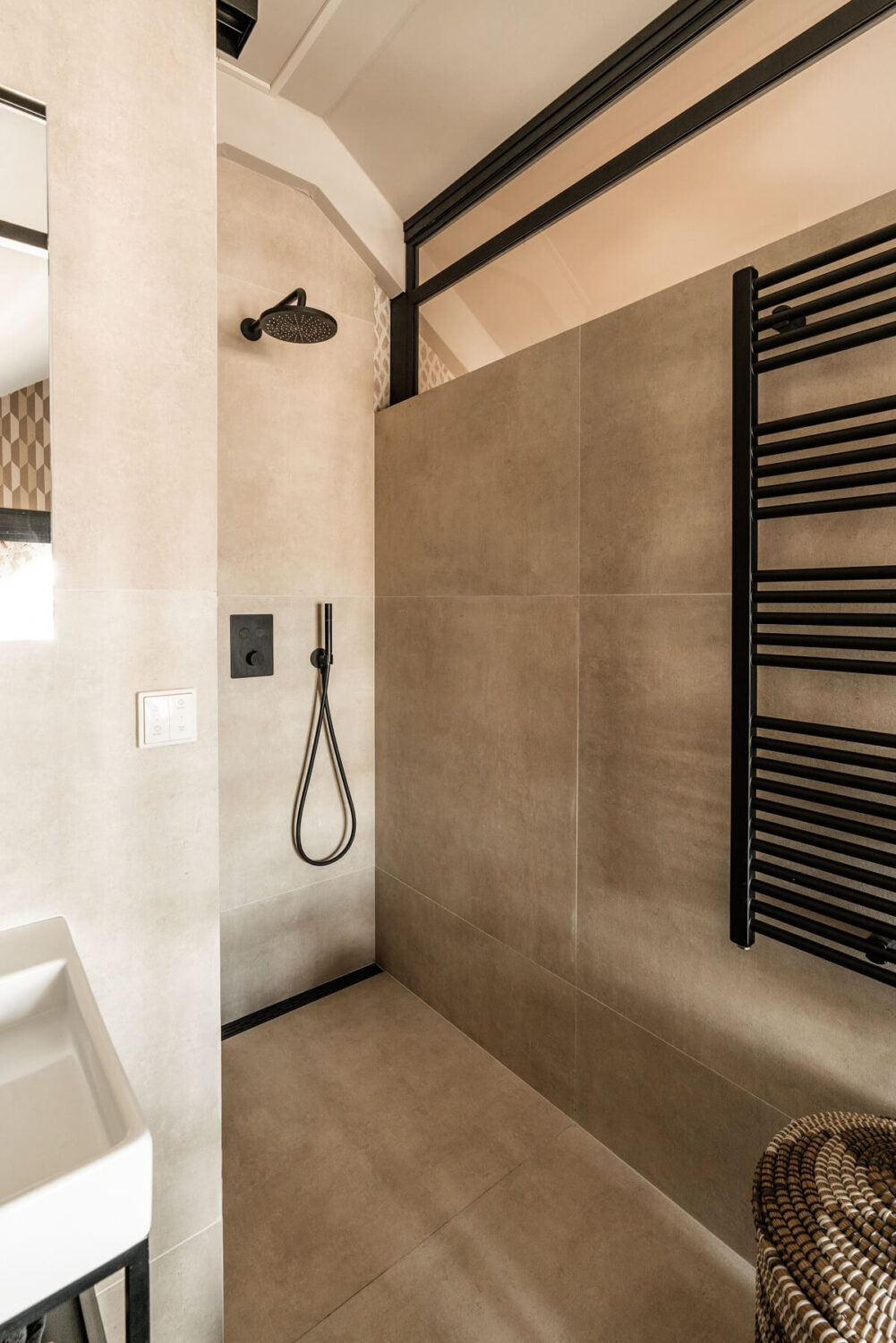 A Stylish Monochrome Penthouse in a Former Prison Building 27 bathroom-gray-tiles-black-fittings-walk-in-shower-nordroom