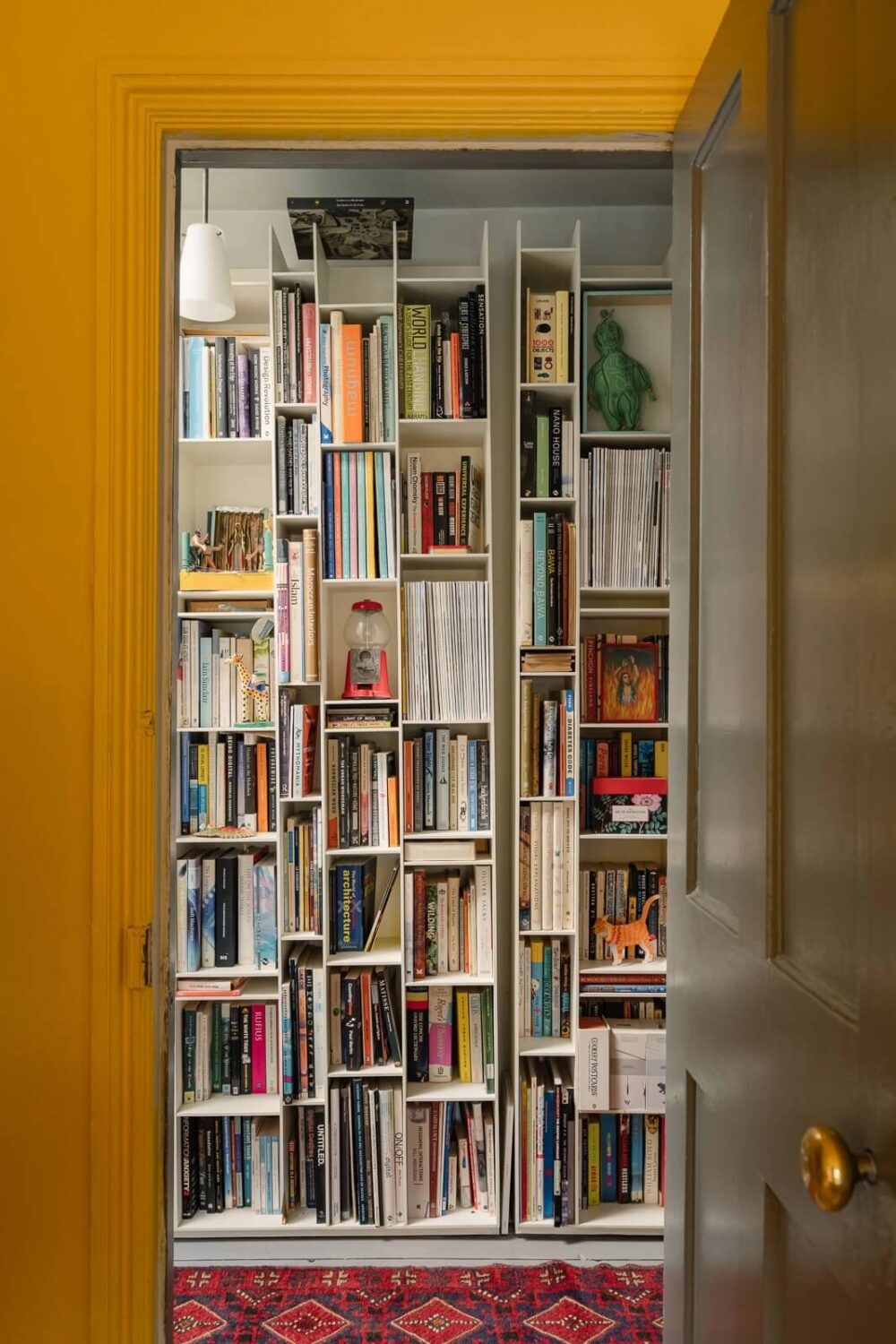 A Victorian House in London with Yellow Color Accents 22 hallway-bookshelves-pink-rug-nordroom