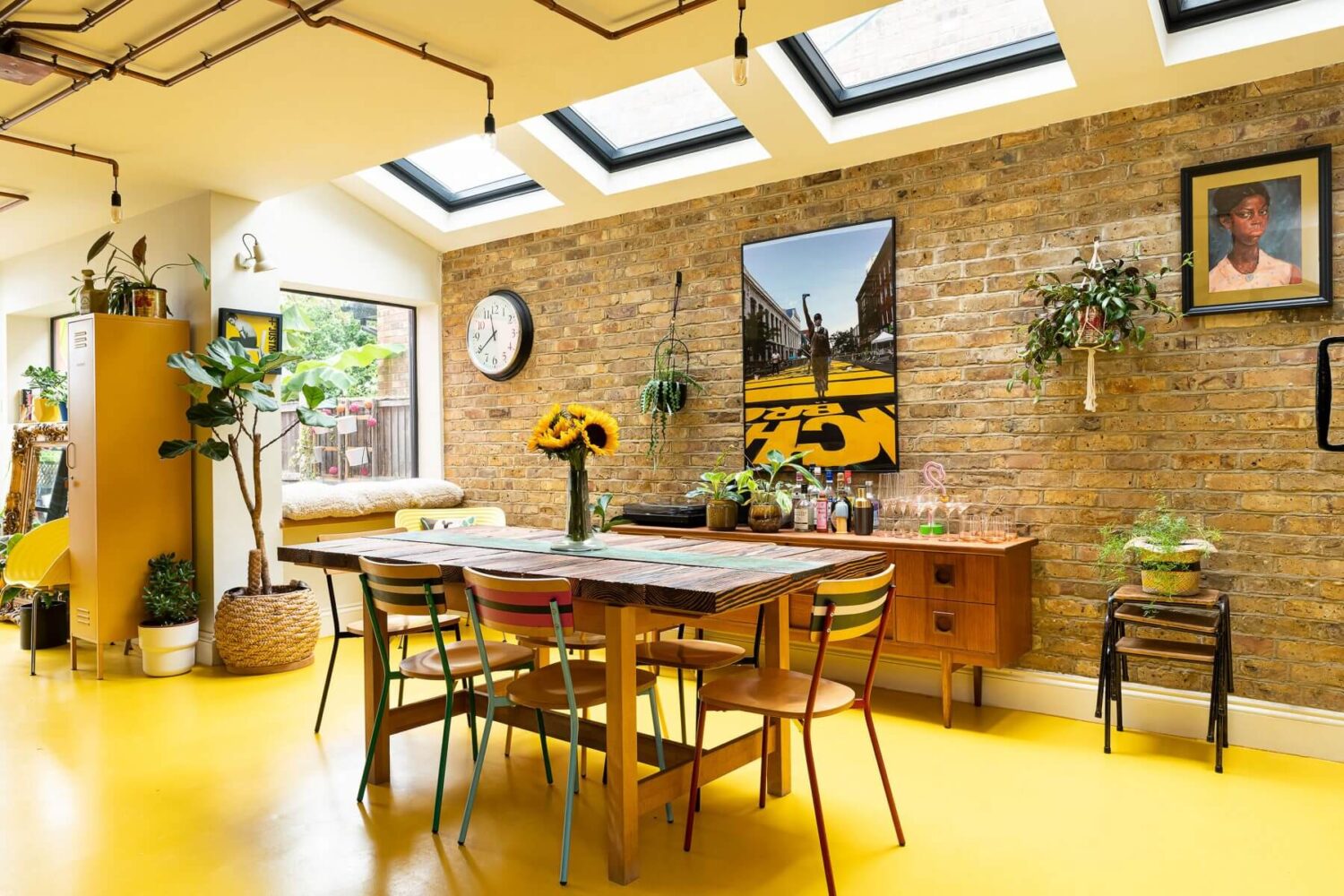 Color Blocked Walls in a Unique Victorian House 11 kitchen-dining-room-brick-wall-skylights-yellow-floor-nordroom