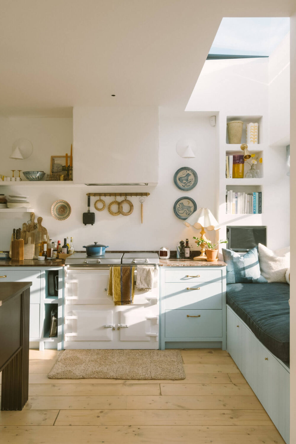 Best of 2022: Kitchens 17 kitchen-window-seat-skylight-light-blue-cabinets-aga-stove-wooden-floor-nordroom