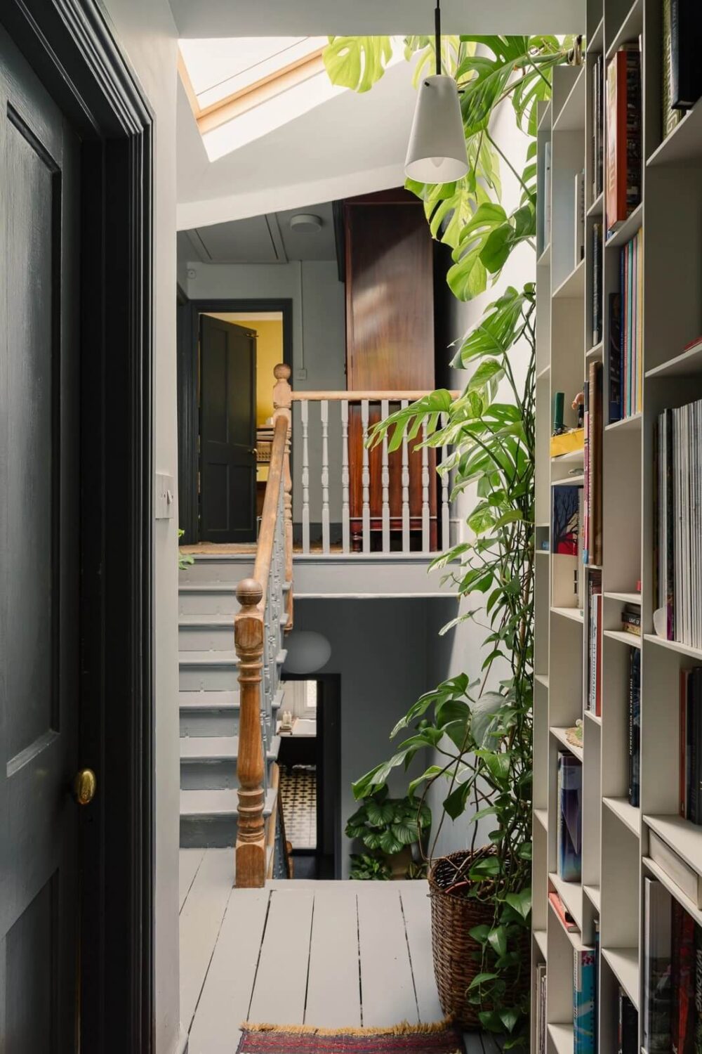 A Victorian House in London with Yellow Color Accents 23 landing-wooden-floor-bookshelves-stairs-plants-skylight-nordroom
