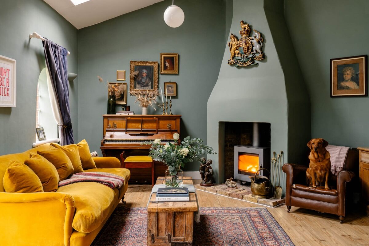 An English Barn Conversion Decorated in Green and Blue 1 living-room-green-walls-farrow-ball-card-room-green-ochre-yellow-sofa-fireplace-vintage-art-nordroom