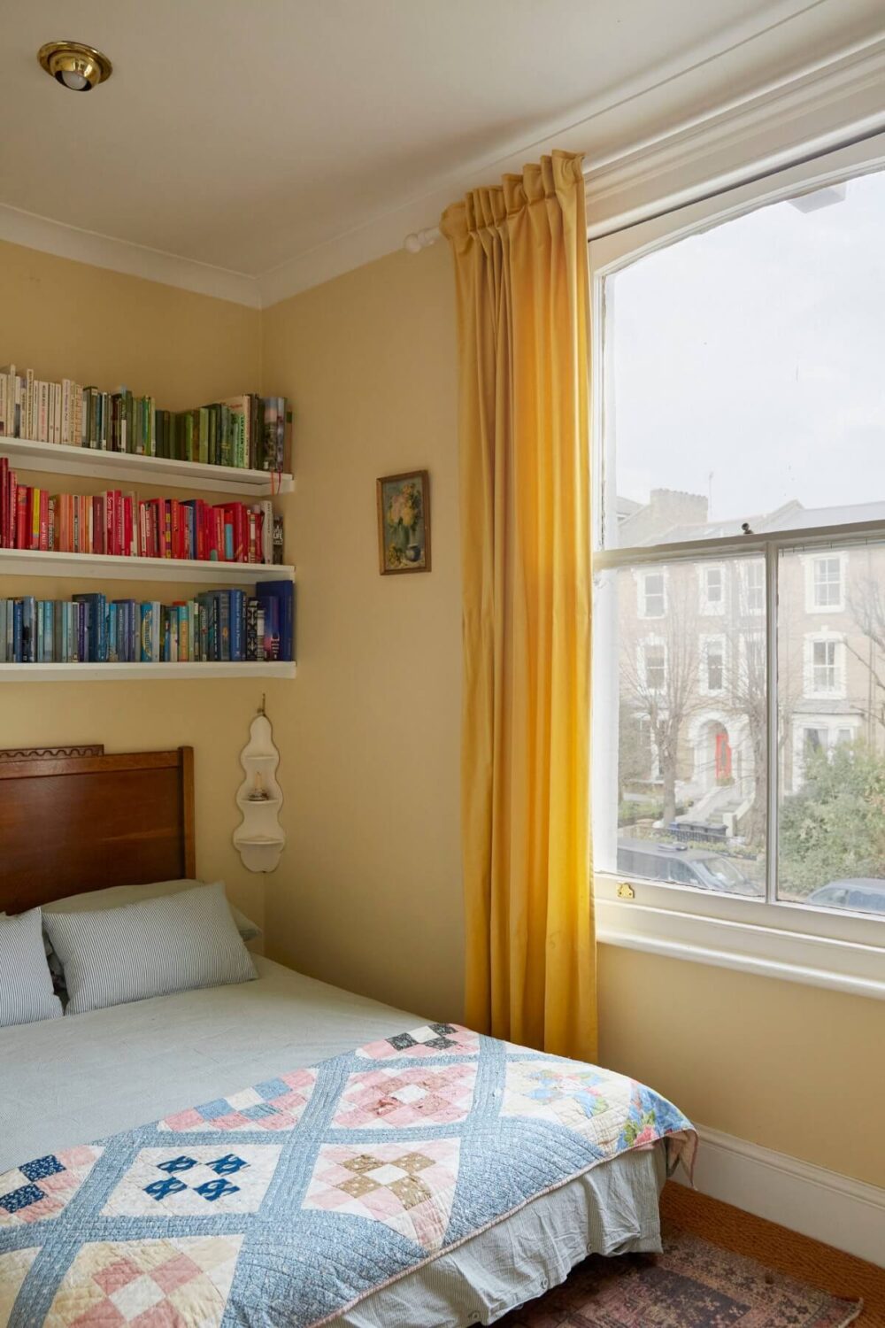 Pastel Colors in a Vintage London Home 10 small-bedroom-pastel-yellow-walls-shelves-nordroom
