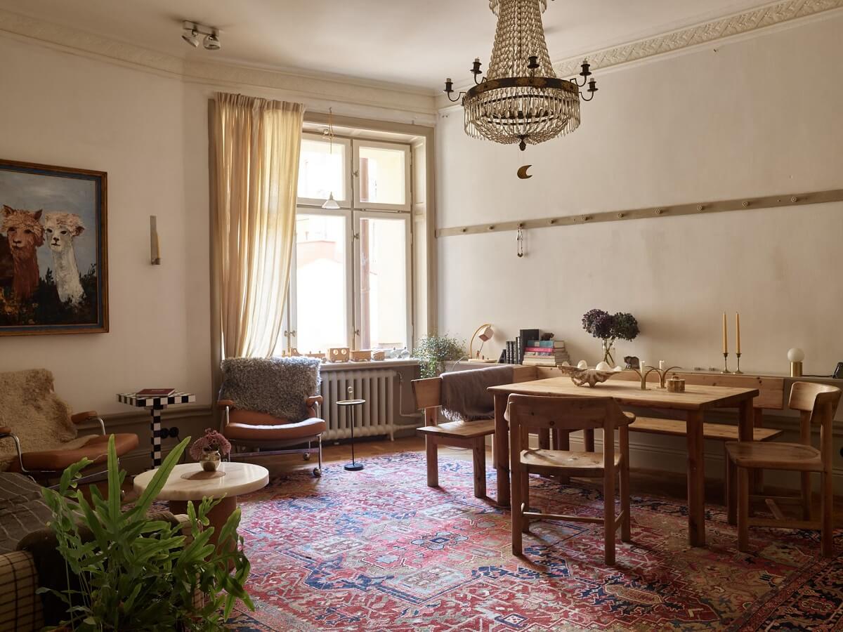 A Beige Vintage Apartment in Stockholm 1 beige-vintage-living-room-large-rug-wooden-dining-area-nordroom