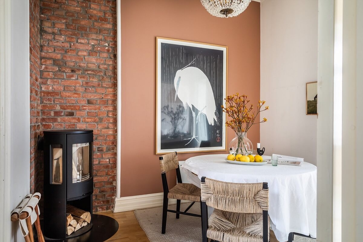 An Oslo Apartment Painted in Warm Color Tones 9 dining-room-exposed-brick-wall-fireplace-earthy-brown-wall-nordroom