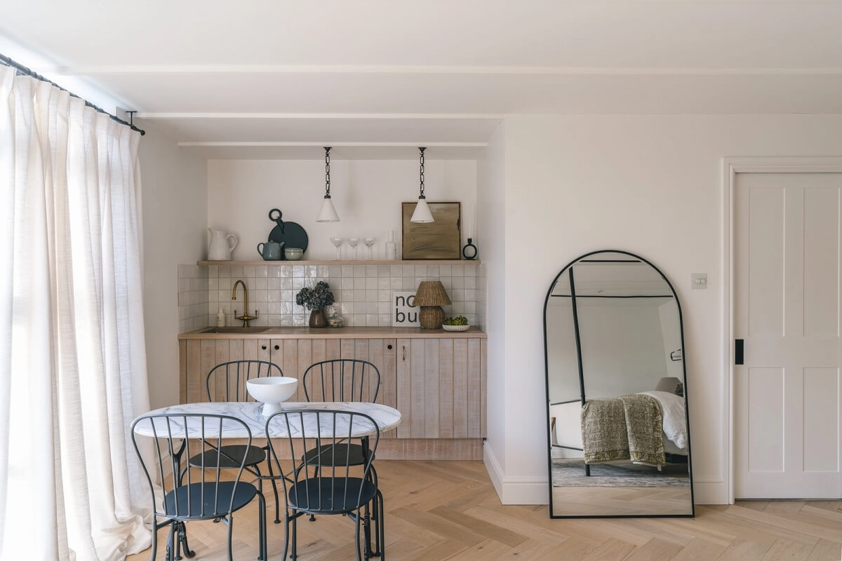 A Victorian Home with a Modern Black Extension 29 guest-house-small-kitchen-arched-mirror-nordroom