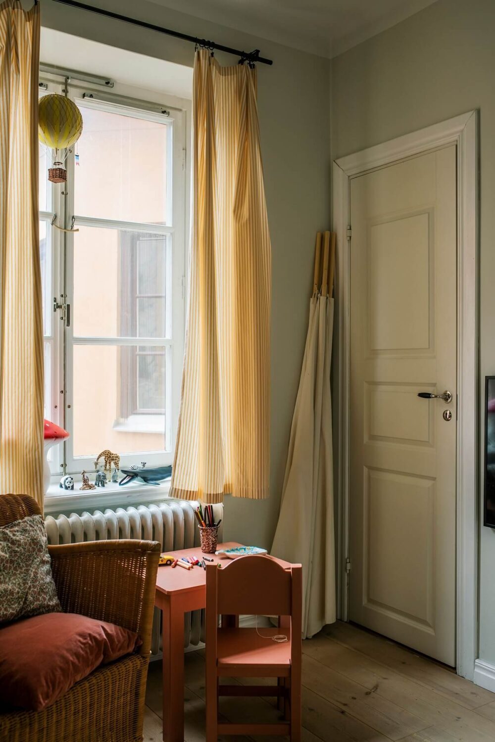 A Serene Light Colored Apartment in Stockholm 14 kids-bedroom-wooden-floor-yellow-curtains-scandinavian-home-nordroom