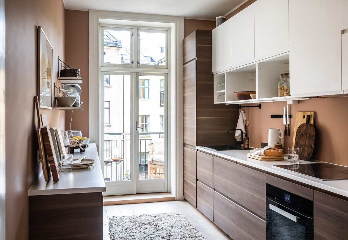 An Oslo Apartment Painted in Warm Color Tones 11 kitchen-wooden-cabinets-brown-walls-nordroom