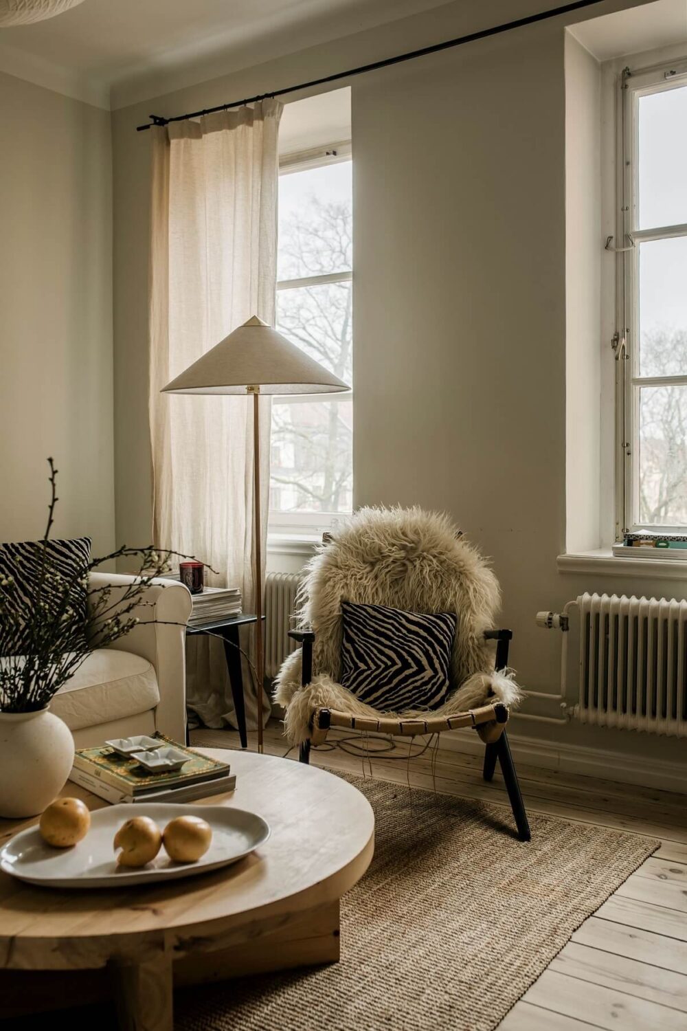 A Serene Light Colored Apartment in Stockholm 3 living-room-wooden-floor-jute-rug-light-colors-nordroom