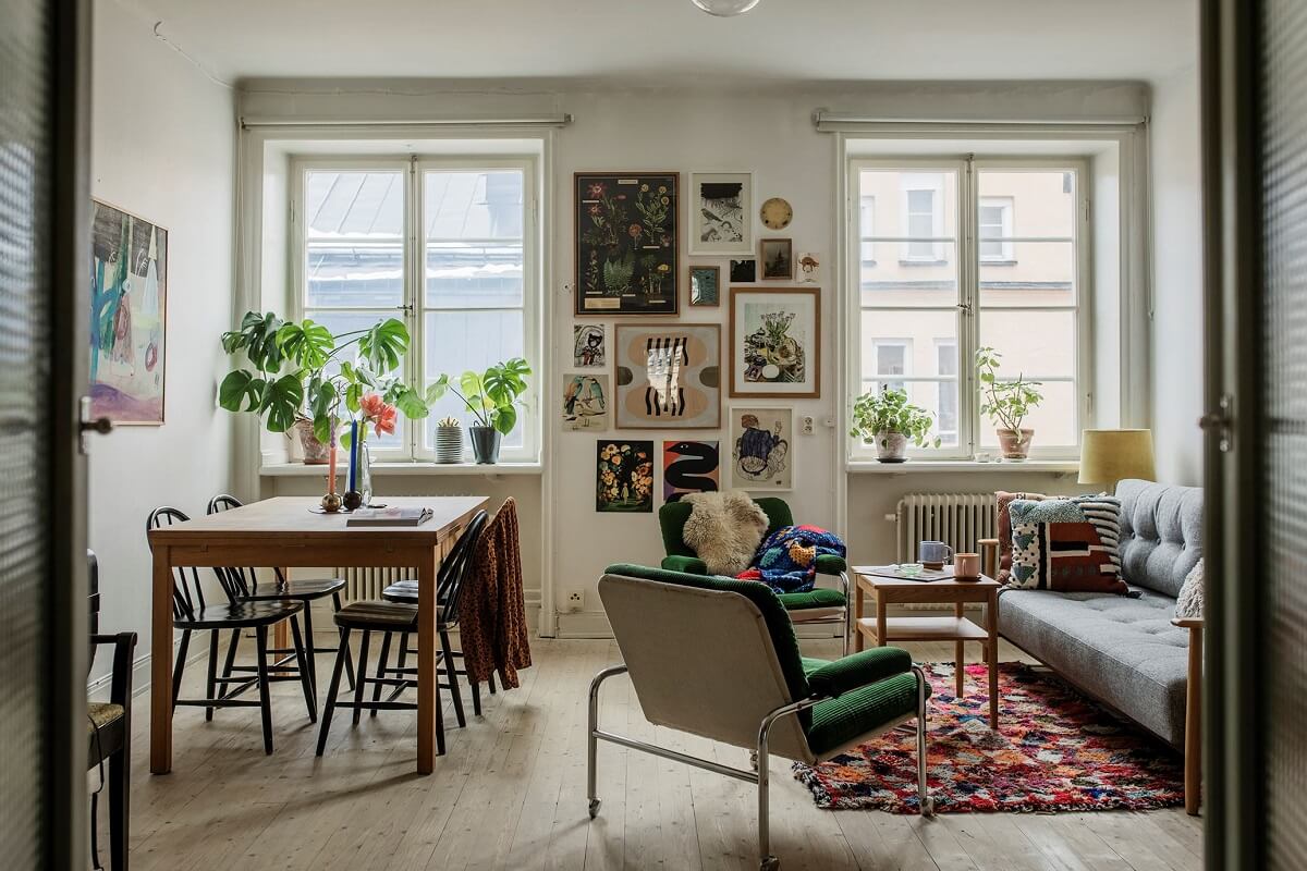 A Small Swedish Apartment Decorated in Midcentury Style 1 living-room-wooden-floor-rug-dining-space-gallery-wall-nordroom