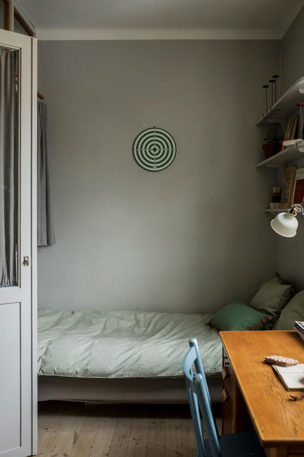 A Small Swedish Apartment Decorated in Midcentury Style 12 small-light-gray-bedroom-shelves-desk-nordroom