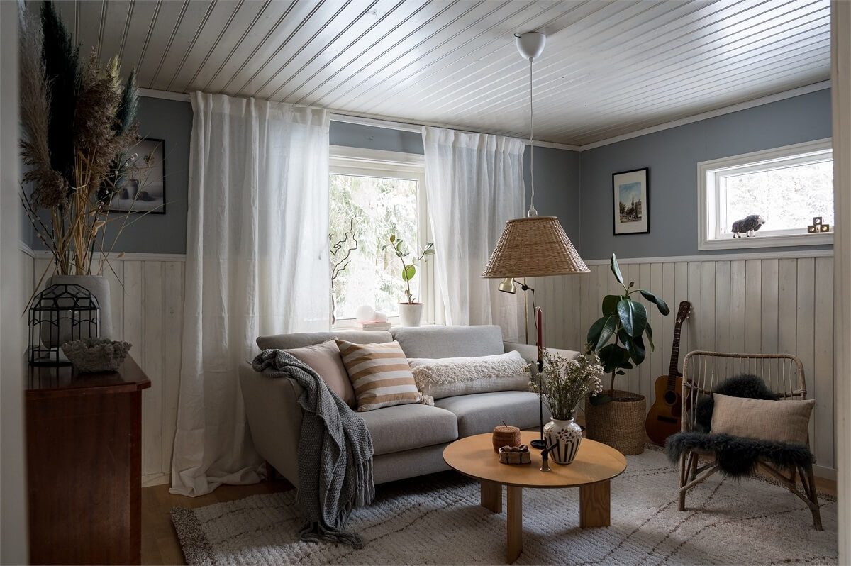 A Charming Countryside Villa in Sweden 9 small-living-room-wood-paneling-light-blue-walls-nordroom