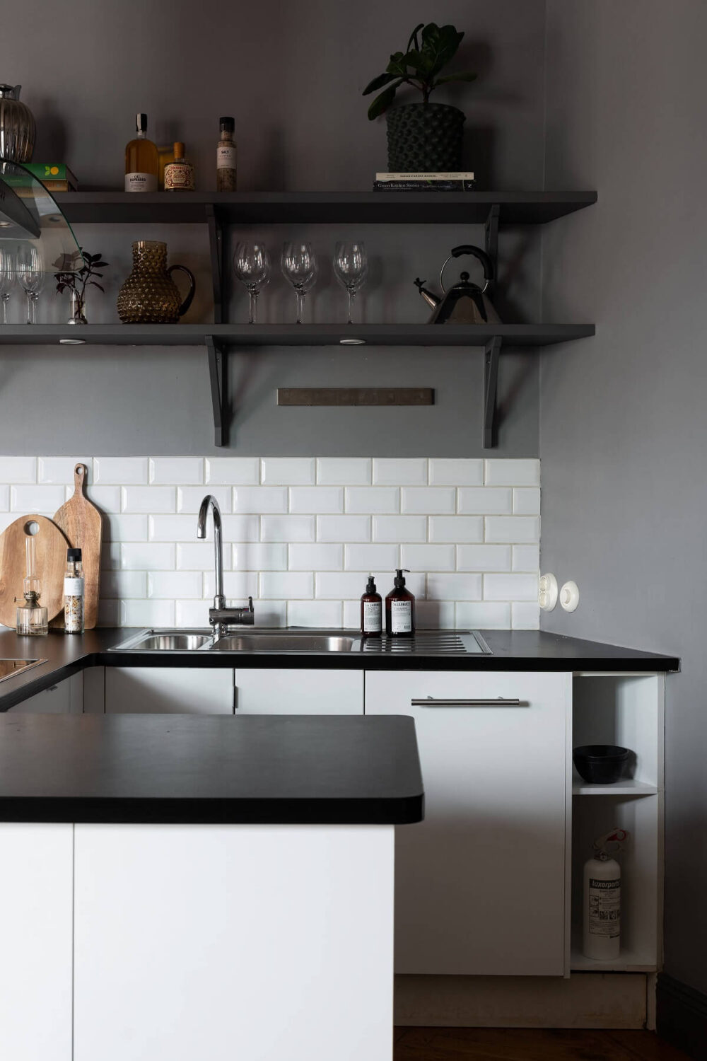 A Stylish Gray Apartment in Stockholm 11 small-u-shaped-kitchen-white-cabinets-open-shelves-nordroom