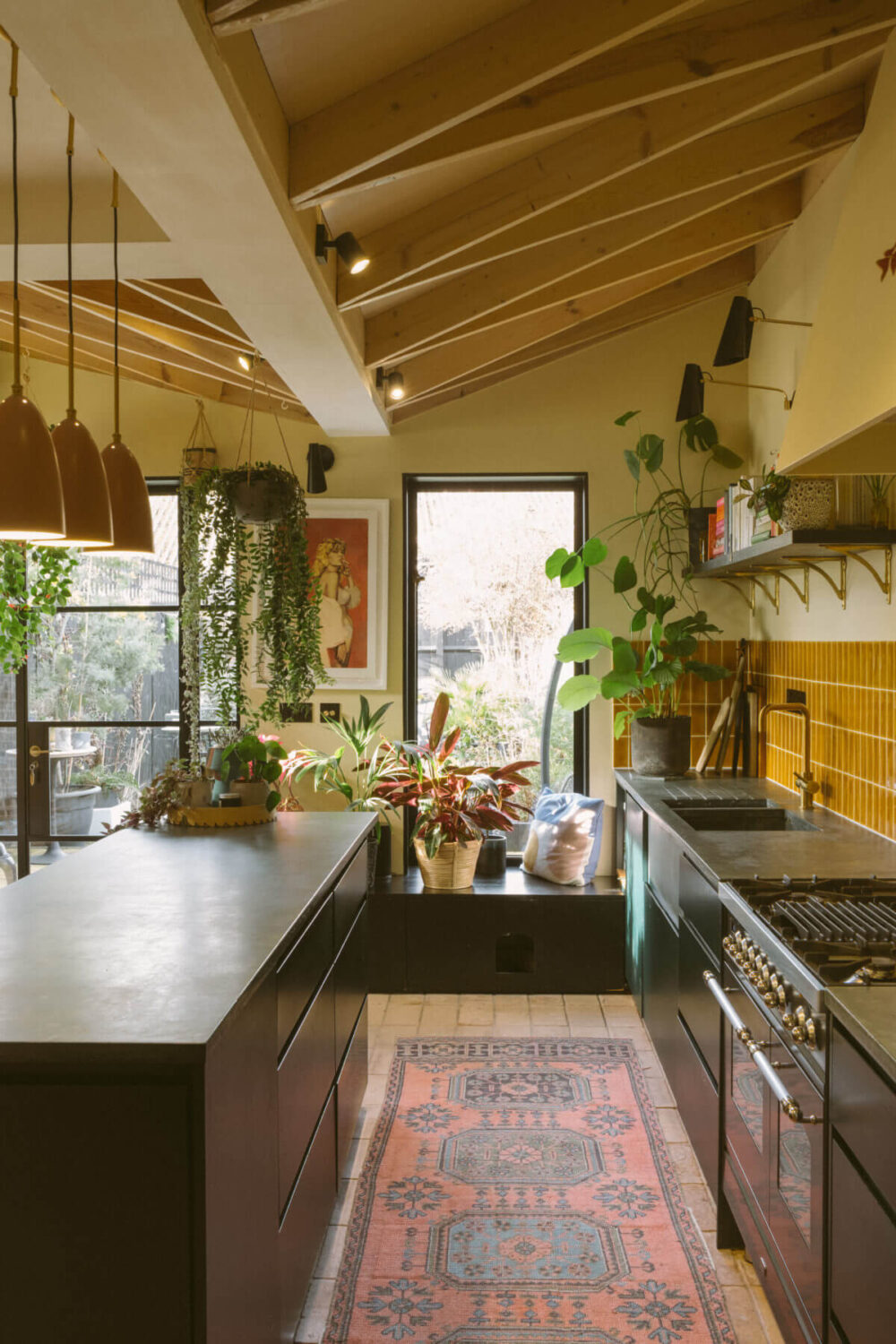 A Victorian House in London Decorated in Warm Color Tones 1 black-kitchen-ochre-yellow-tiles-wooden-beams-slanted-ceiling-nordroom