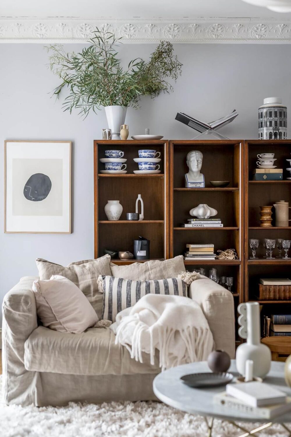 Layered Textiles and Dusty Colors in a Nordic Apartment 4 bookcase-light-blue-walls-sitting-room-nordroom