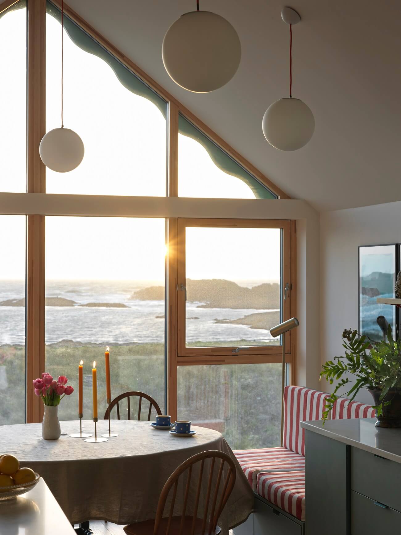 dining-space-bench-striped-textiles-high-pitched-ceiling-sea-view-nordrom