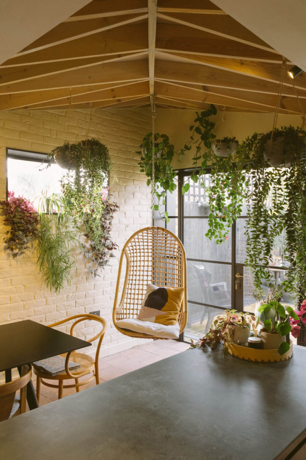 A Victorian House in London Decorated in Warm Color Tones 4 kitchen-exposed-beam-ceiling-rattan-hanging-chair-plants-nordroom