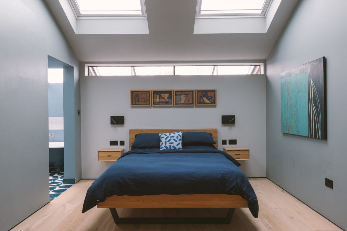 A Modern Split-Level Home with Colorful Rooms 22 light-blue-bedroom-skylights-nordroom