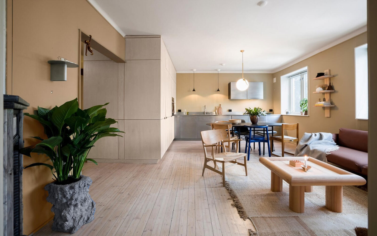 A Modern Oslo Apartment with Custom Furniture and Storage 1 open-plan-living-room-kitchen-stainless-steel-custom-storage-nordroom