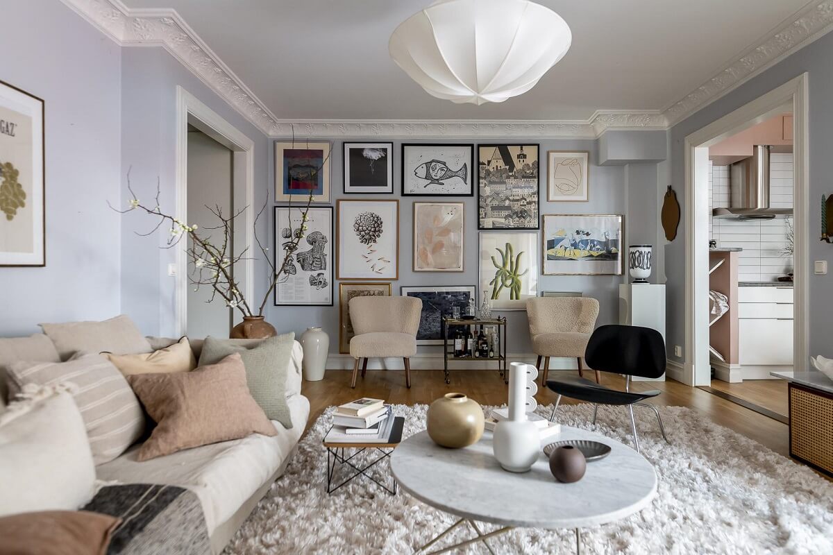 Layered Textiles and Dusty Colors in a Nordic Apartment 1 scandinavian-living-room-gallery-wall-large-rug-nordroom