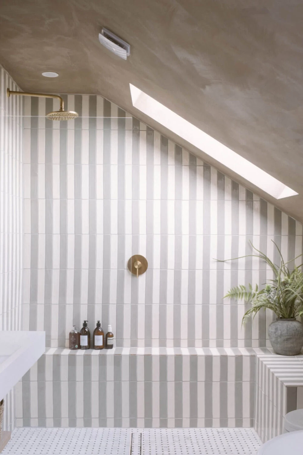 A Serene Renovated Victorian House in London 31 striped-tiles-walk-in-shower-bathroom-slanted-ceiling-nordroom